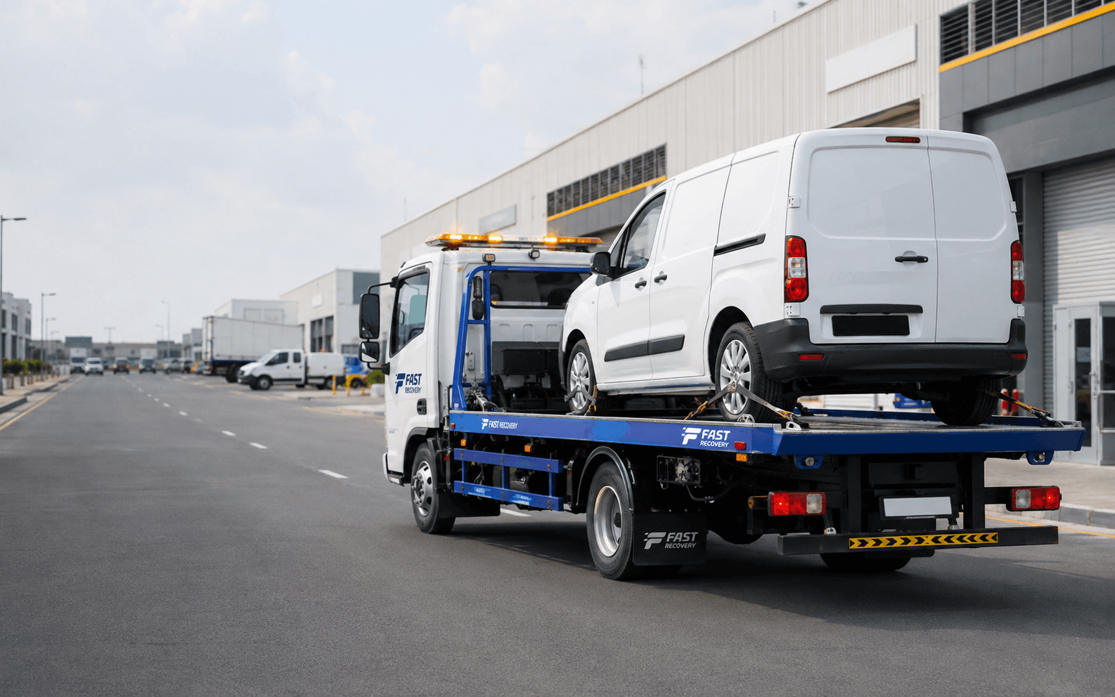 FAST RECOVERY flatbed truck transporting a commercial vehicle in Umm Ramool